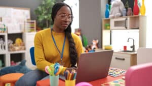 Woman Using A Laptop In An Elementary School